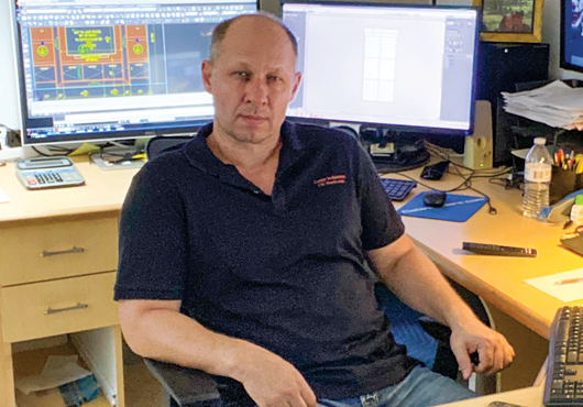 Nicu Iacobescu sits in command central with all his computers surrounding him.